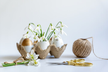 Minimal Easter concept. Festive spring mood, paper box with Easter eggs in light colors and...
