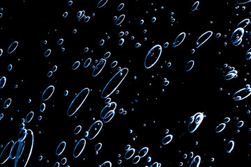 air bubbles in water. dark space background - obrazy, fototapety, plakaty