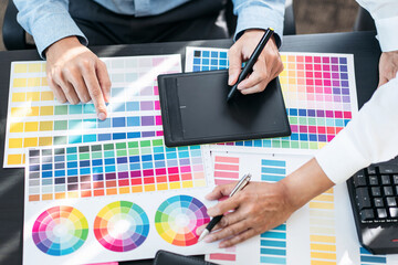 Team of creative graphic designer working on color swatch samples chart for selection coloring in inspiration to create new collection at workplace - 775181300