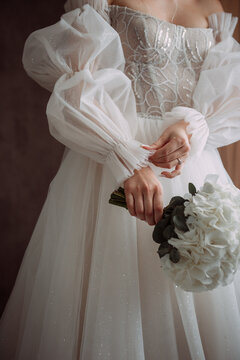 The image depicts a person in a white dress holding a bouquet of flowers 6878.