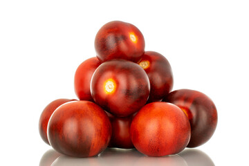 Several ripe black cocktail tomatoes, macro, isolated on white background.