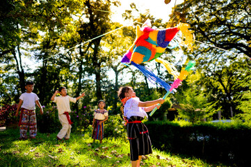 Latina girl fails in her attempt to break the piñata at a Latin birthday celebration.