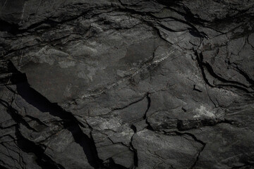 Black rough stone wall texture for background or wallpaper