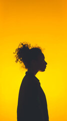 Silhouette of a woman against a yellow background