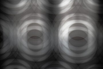 Abstract image in gray tones of multiple blurred circles creating the sensation of depth....