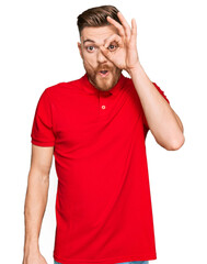 Fototapeta premium Young redhead man wearing casual clothes doing ok gesture shocked with surprised face, eye looking through fingers. unbelieving expression.