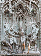 MILAN, ITALY - SEPTEMBER 16, 2024: The detail from main bronze gate of the Cathedral - Flagellation -  by Ludovico Pogliaghi (1906).