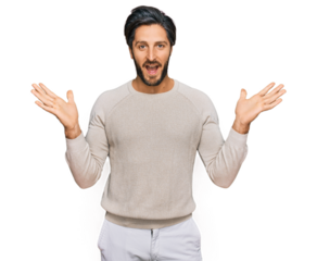 Young hispanic man wearing casual clothes celebrating victory with happy smile and winner expression with raised hands
