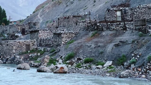 Old villages in Tajikistan. Tajikistan's road along the Zeravshan River near the Pamir highway. Old stone villages in the mountains of the Silk Road. 4К