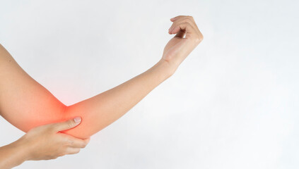 Close up woman's hand holding her elbow . Elbow pain concept.
