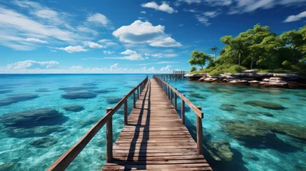 Fotobehang Wooden bridge or pier on tropical white sand beach with clear blue sea and sky on sunny day. Boardwalk into the ocean and turquoise water. Summer holidays background with copy space. © PaulShlykov