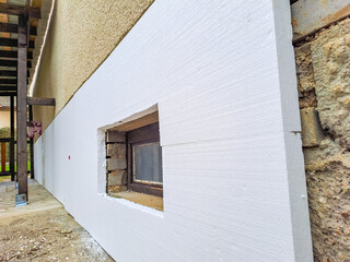 Fototapeta na wymiar installing rigid styrofoam insulation board for energy saving of the house wall