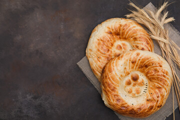  Two Asian flatbread on brown background, top view.