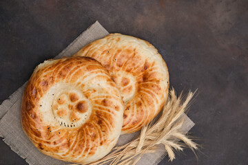 Asian flatbread on brown background, top view.