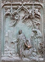 MILAN, ITALY - SEPTEMBER 16, 2024: The detail from main bronze gate of the Cathedral - Apparition to Mary Magdalen -  by Ludovico Pogliaghi (1906).