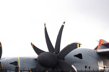 Airplane engine. Blades of a gray airplane on the wing. Military cargo plane