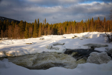 Winter landscape with a waterfall and snow. Russia, Karelia