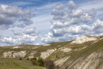 Chalk hills in Ulyanovsk region, Russia. Yellow flowers in the foreground