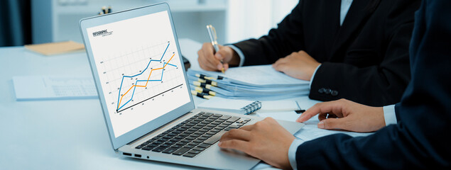 Business intelligence analyst team use BI software on laptop to analyze financial data dashboard....