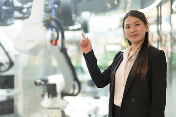 Confident businesswoman with robotics technology - 775232103