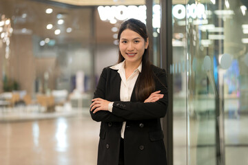 Confident businesswoman in modern office environment - 775232109