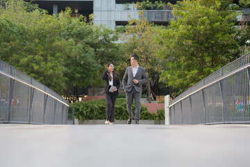Business professionals walking in modern urban setting - 775232560