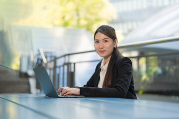 Professional woman working outdoors on laptop - 775232775