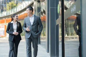 Business colleagues walking together in modern business district