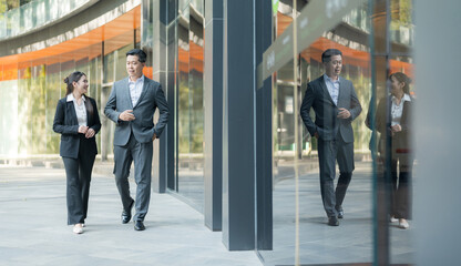 Business colleagues walking together in modern business district
