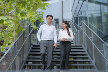 Business colleagues walking downstairs outdoors