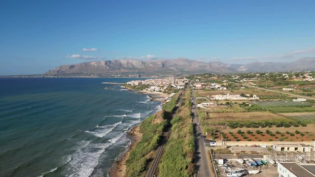 Aerial shot of the sea in Balestrate, Sicily, with waves crashing on the rocky coastline.