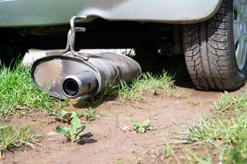 Broken exhaust and muffler of a car, rusted silencer fallen down on the road, breakdown of vehicle - 775240182