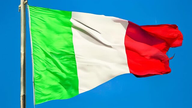 the Italy flag waving, green white and red colors. on blue sky background. Italian army symbol.