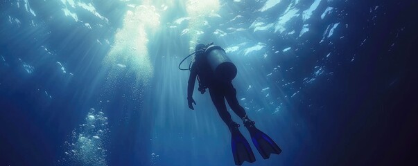 A breathtaking underwater shot of a scuba diver exploring the mysterious ocean depths, highlighting adventure and discovery - obrazy, fototapety, plakaty