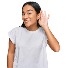 Young asian woman wearing casual white t shirt smiling with hand over ear listening an hearing to...