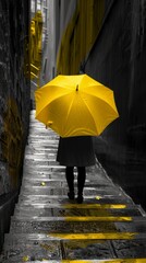Person with a yellow umbrella in a black and white alley