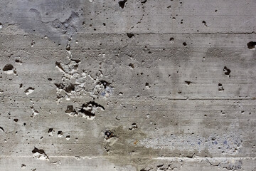 Abstract weathered wall background. Close-up view of old faded dirty dark grey concrete wall with...