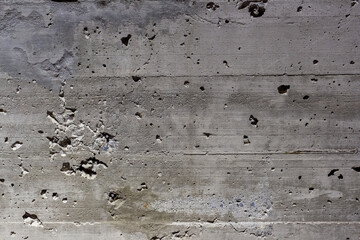 Abstract weathered wall background. Close-up view of old faded dirty dark grey concrete wall with paint residue and mold on stone surface. Copy space for your text or decoration. Soft focus.