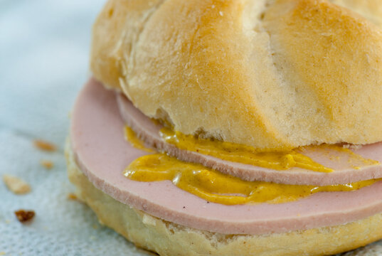 sandwich with poor quality salami parizer made of a paste consist in pork scraps pig skin and other low quality meats poor poverty concept