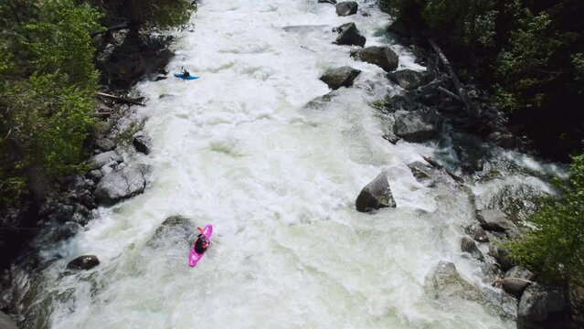 Kayaker Paddling Whitewater Rapids Followed by Drone
