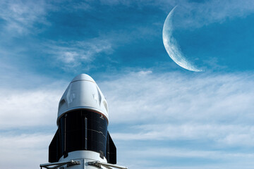 Cargo spacecraft launch on sky background with Moon. Elements of this image furnished by NASA.
