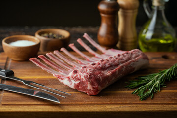 fresh lamb chop on wooden cutting board