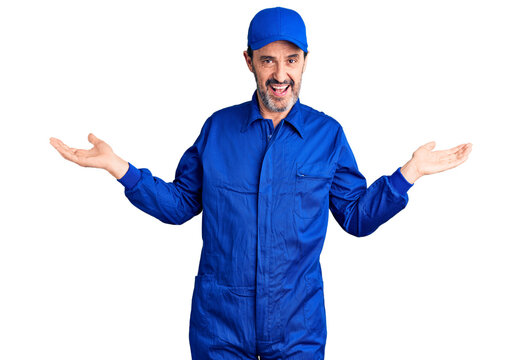 Middle age handsome man wearing mechanic uniform smiling showing both hands open palms, presenting and advertising comparison and balance
