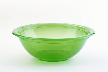 A simple green glass bowl on a clean white surface. Perfect for kitchen and cooking concepts