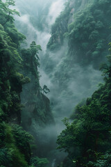 A waterfall cascades through foggy trees in a green forest - obrazy, fototapety, plakaty