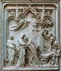 MILAN, ITALY - SEPTEMBER 16, 2024: The detail from main bronze gate of the Cathedral -   Visitation...