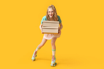 Beautiful young happy woman in vintage roller skates with cardboard boxes on yellow background