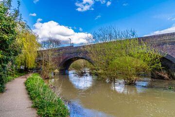 A view along the bank of the River Biam towards the Aylestone viaduct in Leicester, UK in Springtime