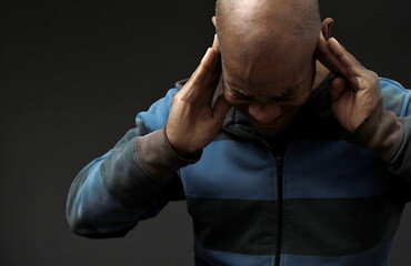 deaf man suffering from deafness and hearing loss on gray background with people stock image stock...