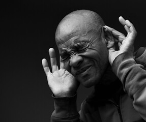 deaf man suffering from deafness and hearing loss on gray background with people stock image stock...